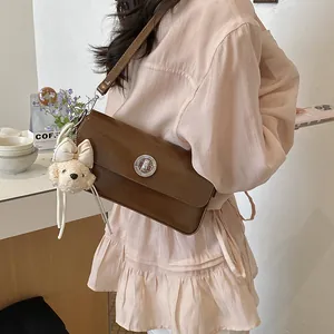 Stylish brown shoulder bag for women, chic commuter crossbody bag with cute bear pendant.