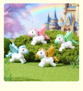 Four colorful mini pearlescent winged pegasus unicorn figurines displayed on green mossy grass