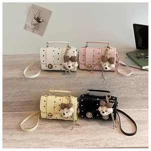 Charming polka dot Boston handbag with cute bear pendant, versatile casual shoulder bag.