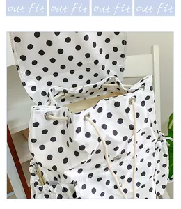 Chic minimalist black and white polka dot backpack with drawstring and flap closure for daily use.