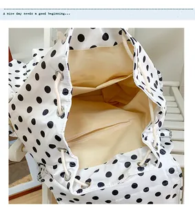 Detailed view of the stylish white and black polka dot casual drawstring backpack interior.