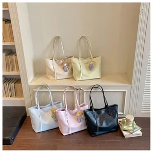 Minimalist large capacity tote bag for women, casual commuter shoulder bag with cute bear pendant.