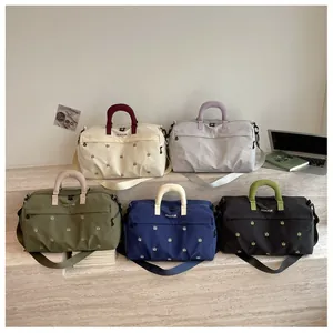 Detailed view of multi-color travel duffel bags showing neat arrangement and clean design.