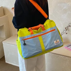 Colorblock travel duffel bag, large capacity portable gym bag, casual commuter luggage bag.