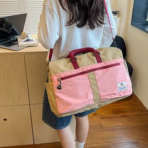 Color-block travel duffel bag large capacity portable luggage bag for business commuting.