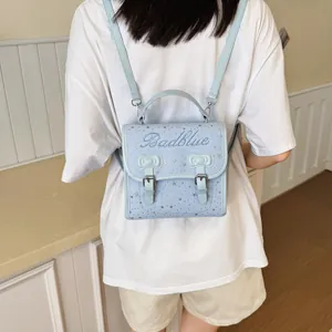 Zaino mini azzurro alla moda da donna con grazioso motivo a stelle e design a fiocco per viaggi.