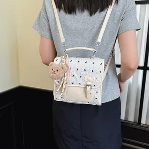 Collegiate bow print small backpack with cute bear pendant for women daily casual travel stylish