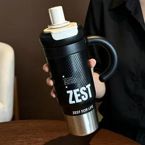 Detailed view of large capacity black insulated tumbler with handle and stylish text print.