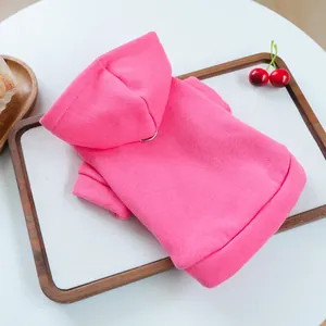 Close-up detail of a bright pink pet hoodie for small dogs, featuring a cute hood and soft knit.