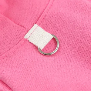 Detail view of the pet hoodie showing sturdy metal D-ring and durable woven loop on pink fabric.