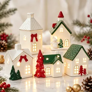 Set of glowing ceramic Christmas houses and tree ornaments for festive home table decor