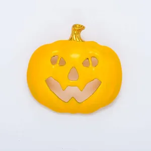 Halloween pumpkin enamel brooch detail, cute cartoon holiday jewelry accessory for kids.