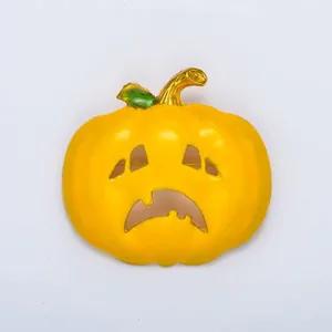 Halloween pumpkin brooch detail close up view showing sad face and enamel finish.