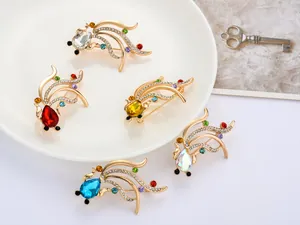 Detailed view of multiple rhinestone crystal goldfish brooches featuring colorful gemstones.