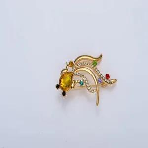 Gold fish brooch detail, sparkling rhinestones and colorful crystal gems, fashion jewelry.
