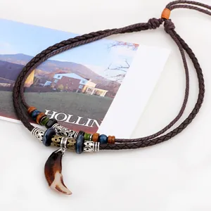 Vintage ethnic style mens necklace with brown woven cord and decorative tooth pendant