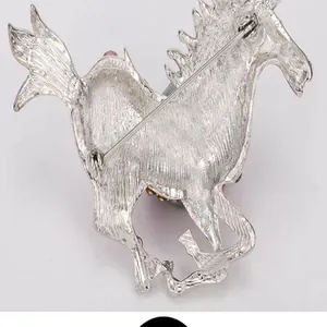 Back detail view of the elegant galloping horse brooch, showing sturdy metal pin clasp.