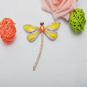 Charming dragonfly brooch with vibrant enamel and sparkling rhinestones. Elegant fashion item.