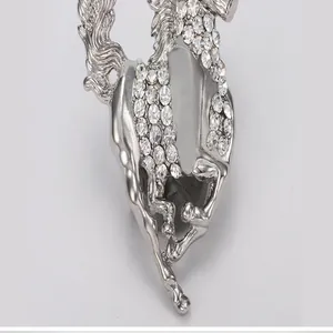 Detail shot of a sparkling silver-tone rhinestone horse brooch, exquisite crystal alloy detail