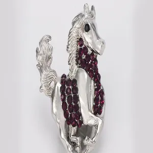 Exquisite silver alloy prancing horse brooch detailed with sparkling purple crystal rhinestones.