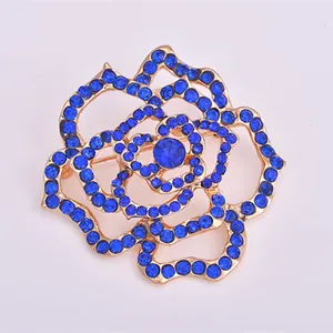 Elegant blue rhinestone rose brooch, gold tone alloy floral pin for women fashion apparel.