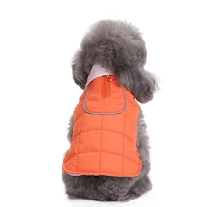 Detailed rear view of a warm orange quilted pet winter jacket worn by a gray poodle dog.