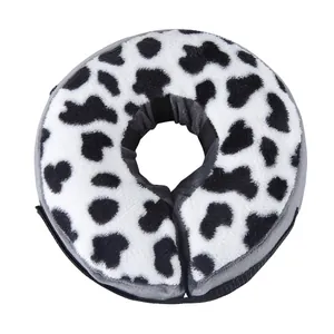 Plush cow print pet recovery collar detail, soft fabric, comfortable anti-bite neck cone.