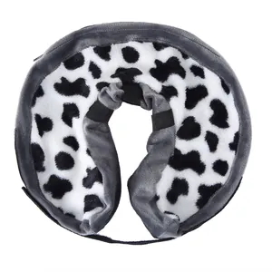 Close-up detail of the soft plush pet recovery collar with cute cow print design.