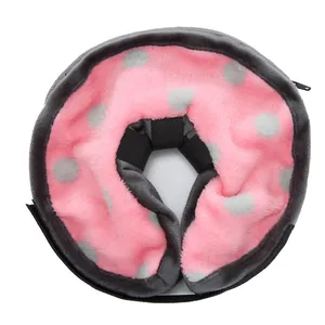 Close-up of soft plush pink and grey polka dot inflatable pet recovery collar detail.