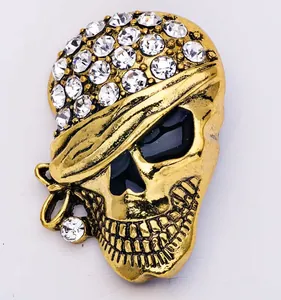 Exquisite rhinestone skull brooch in antique gold finish, featuring pirate eyepatch design.