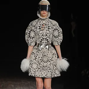Detail view of the festive Christmas snowman pendant sweater chain showcased on runway.