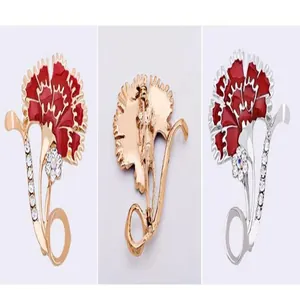 Detailed view of the exquisite carnation brooch featuring red enamel and sparkling rhinestones.