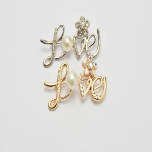 Fashionable LOVE letter brooch set with pearls and rhinestones for women stylish daily wear.
