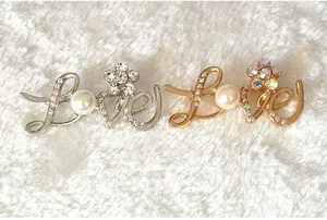 Korean style letter LOVE brooch with shimmering rhinestones and elegant pearls, perfect accessory.