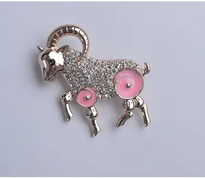 Exquisite rose gold zodiac ram brooch paved with sparkling rhinestones and pink enamel.