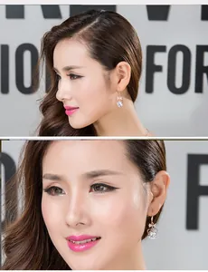 Close-up view of elegant heart-shaped zircon drop earrings worn by model, sparkling details.
