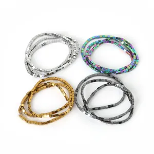 Close-up of small hematite cube beads in silver, gold, gunmetal, and rainbow