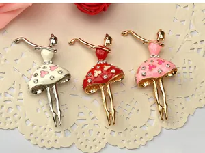 Close-up of three cute ballerina girl alloy rhinestone brooches in white, red and pink.