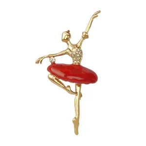Detailed close-up of the gold ballerina brooch showing rhinestones and red enamel details.