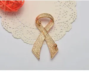 Gold tone awareness ribbon brooch pin metal apparel accessory versatile fashion jewelry item