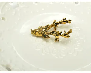 Vintage gold deer head brooch detail shot, elegant Christmas clothing accessory pin and decor.