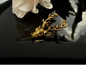 Detailed view of vintage gold deer head brooch, exquisite animal corsage pin for apparel.