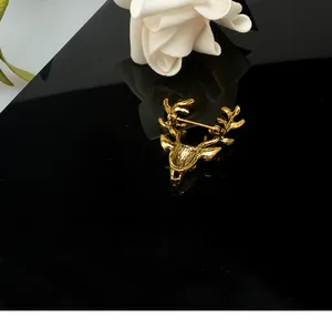 Gold tone deer head brooch detail shot showing the pin back and vintage design.