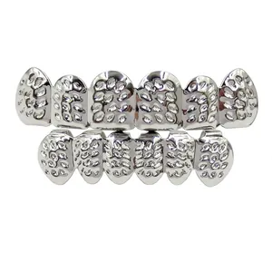 Detailed close-up of metallic hip-hop teeth grillz with unique textured surface design.