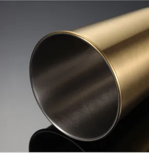 Close-up detail of golden brushed stainless steel pint cup showing smooth rim and texture