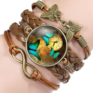 Close-up of handmade multi-layer leather bracelet with vintage butterfly charms and gem