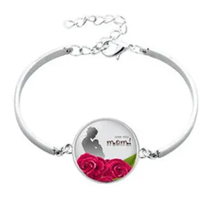 Detail of silver bangle charm with mother-child silhouette and red roses pattern