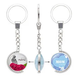 Detail view of a rotating silver keychain with 'MOM' heart and mother-child rose graphic
