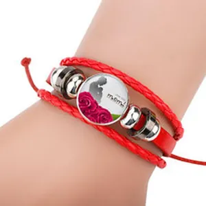 Macro view of a red multilayer leather bracelet featuring a mom and child pendant