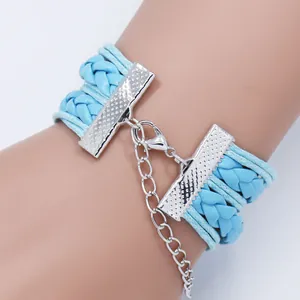 Detailed view of the silver lobster clasp and extension chain on a blue braided bracelet